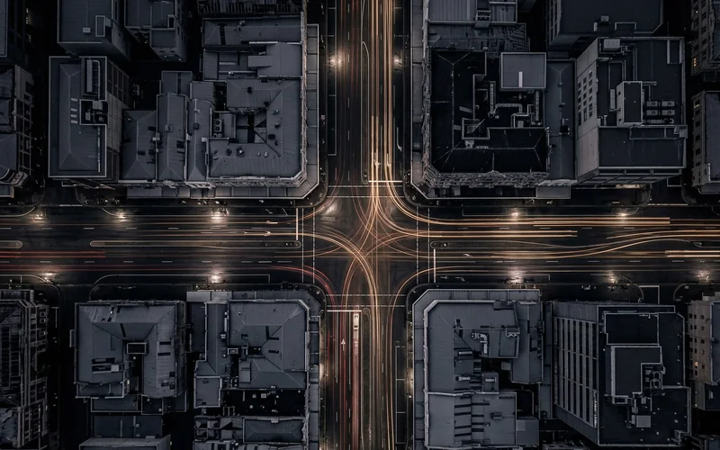 Aerial night view of an urban intersection with vehicle light trails